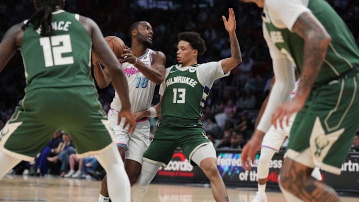 Apr 5, 2025; Miami, Florida, USA;  Miami Heat guard Alec Burks (18) drives to the basket as Milwaukee Bucks guard Ryan Rollins (13) defends during the first half at Kaseya Center. Mandatory Credit: Jim Rassol-Imagn Images