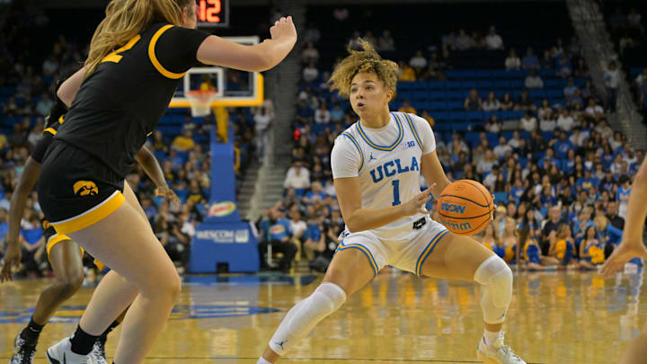 Feb 1, 2026; Los Angeles, California, USA;  UCLA Bruins guard Kiki Rice (1) is defended by Iowa Hawkeyes center Layla Hays (12) in the first half at Pauley Pavilion presented by Wescom Financial. Mandatory Credit: Jayne Kamin-Oncea-Imagn Images