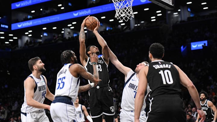 Feb 6, 2024; Brooklyn, New York, USA; Brooklyn Nets center Nic Claxton (33) shoots as Dallas Mavericks forward Maxi Kleber (42), forward Derrick Jones Jr. (55) and guard Luka Doncic (77) defend during the third quarter at Barclays Center. Mandatory Credit: John Jones-Imagn Images