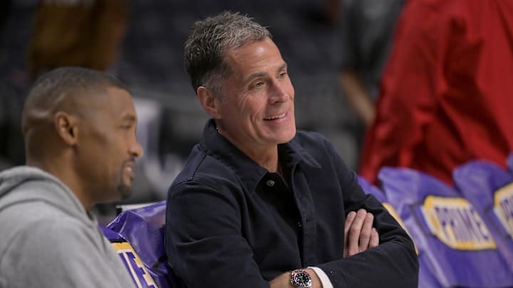 Nov 21, 2024; Los Angeles, California, USA;  Los Angeles Lakers general manager Rob Pelinka, right, talks with Leroy Sims, director of player performance & health, prior to the game against the Orlando Magic at Crypto.com Arena. Mandatory Credit: Jayne Kamin-Oncea-Imagn Images