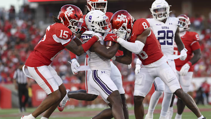 Aug 28, 2025; Houston, Texas, USA; Houston Cougars defensive back Will James (15) and defensive back Kentrell Webb (8) attempt to tackle Stephen F. Austin Lumberjacks wide receiver Bugs Mortimer (9) during the first quarter at TDECU Stadium. Mandatory Credit: Troy Taormina-Imagn Images Aug 28, 2025; Houston, Texas, USA; Houston Cougars defensive back Will James (15) and defensive back Kentrell Webb (8) attempt to tackle Stephen F. Austin Lumberjacks wide receiver Bugs Mortimer (9) during the first quarter at TDECU Stadium. Mandatory Credit: Troy Taormina-Imagn Images