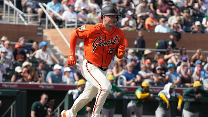 Feb 23, 2026; Scottsdale, Arizona, USA; San Francisco Giants third baseman Matt Chapman (26) runs to first against the Athletics in the second inning at Scottsdale Stadium. Mandatory Credit: Rick Scuteri-Imagn Images
