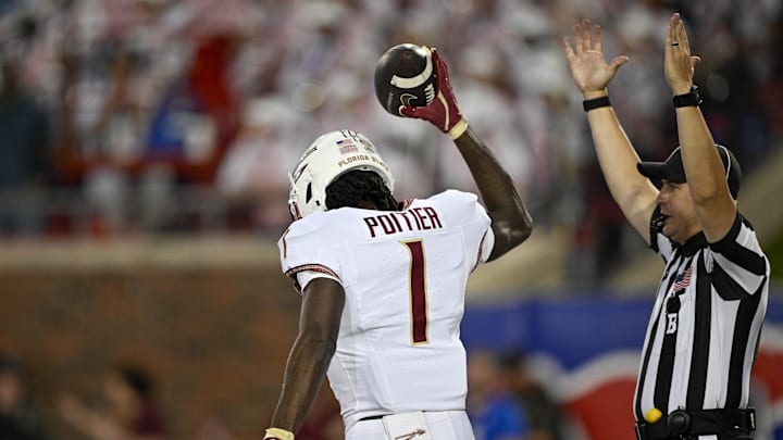 Sep 28, 2024; Dallas, Texas, USA; Florida State Seminoles wide receiver Kentron Poitier (1) celebrates after he scores a touchdown against the Southern Methodist Mustangs during the first quarter at Gerald J. Ford Stadium. Mandatory Credit: Jerome Miron-Imagn Images