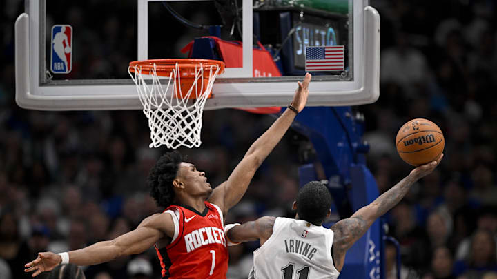 Feb 8, 2025; Dallas, Texas, USA; Dallas Mavericks guard Kyrie Irving (11) and Houston Rockets forward Amen Thompson (1) in action during the game between the Dallas Mavericks and the Houston Rockets at the American Airlines Center. Mandatory Credit: Jerome Miron-Imagn Images