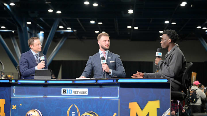  Michigan Wolverines defensive back Mike Sainristil (0) talks with Big Ten Network personality Dave Revsine (left) and former Michigan Wolverines player Jake Butt r. Mandatory Credit: Maria Lysaker-Imagn Images