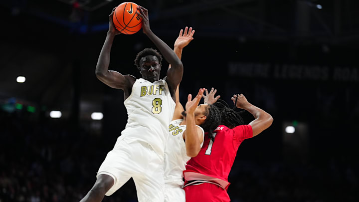 Jan 10, 2026; Boulder, Colorado, USA; Colorado Buffaloes forward Bangot Dak (8) brings in a rebound in the first half against the Texas Tech Red Raiders at CU Events Center. Mandatory Credit: Ron Chenoy-Imagn Images