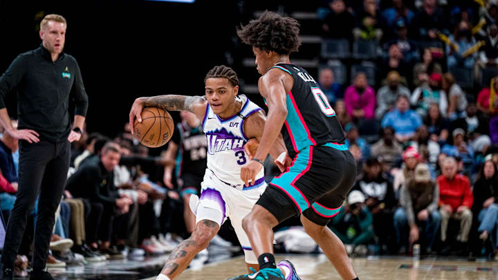 Dec 12, 2025; Memphis, Tennessee, USA; Utah Jazz guard Keyonte George (3) drives into Memphis Grizzlies forward Jalen Wells (0) in the second half at FedExForum. Mandatory Credit: Matthew Smith-Imagn Images