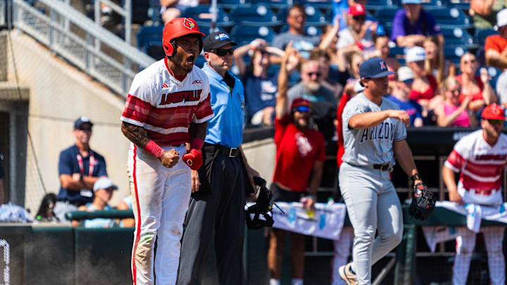 Jun 15, 2025; Omaha, Neb, USA; Louisville Cardinals left fielder Zion Rose (32) celebrates after scoring on a RBI single against the Arizona Wildcats during the eighth inning at Charles Schwab Field. Mandatory Credit: Dylan Widger-Imagn Images