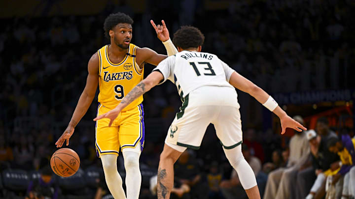 Mar 20, 2025; Los Angeles, California, USA; Los Angeles Lakers guard Bronny James (9) looks to pass against Milwaukee Bucks guard Ryan Rollins (13) during the second half at Crypto.com Arena. Mandatory Credit: Jonathan Hui-Imagn Images