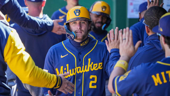 Apr 5, 2026; Kansas City, Missouri, USA; Milwaukee Brewers second baseman Brice Turang (2) celebrates with team mates in the dugout after scoring against the Kansas City Royals during the seventh inning at Kauffman Stadium. Mandatory Credit: Denny Medley-Imagn Images