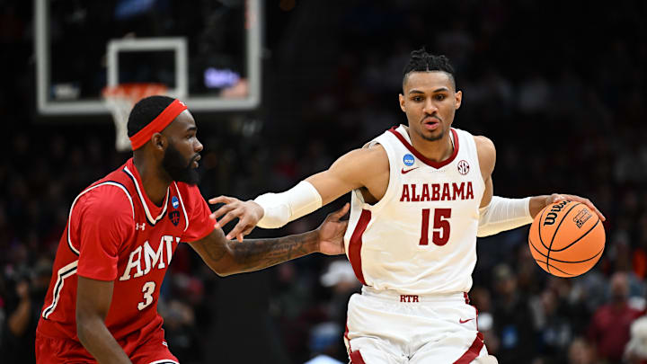 Mar 21, 2025; Cleveland, OH, USA; Alabama Crimson Tide forward Jarin Stevenson (15) dribbles the ball defended by Robert Morris Colonials guard Amarion Dickerson (3) in the first half during the NCAA Tournament First Round at Rocket Arena. Mandatory Credit: Ken Blaze-Imagn Images