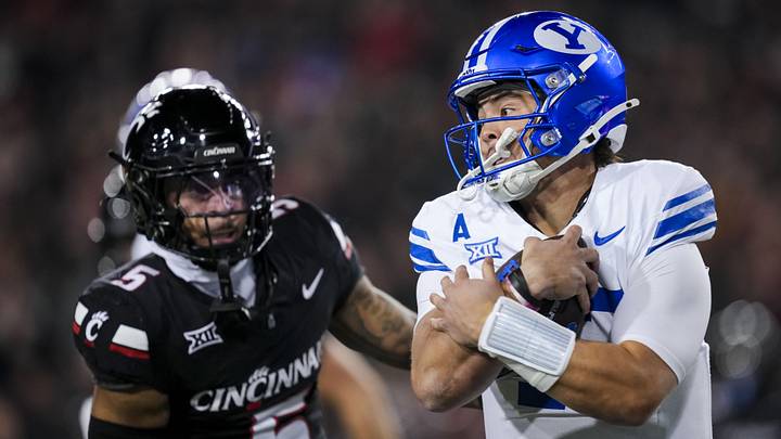 Nov 22, 2025; Cincinnati, Ohio, USA; BYU Cougars quarterback Bear Bachmeier (47) runs with the ball against the Cincinnati Bearcats in the first half at Nippert Stadium. Mandatory Credit: Aaron Doster-Imagn Images