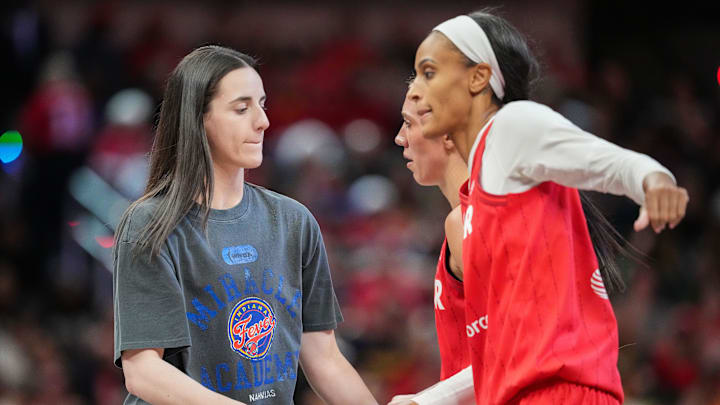 Indiana Fever guard Caitlin Clark (22) high-flves Indiana Fever forward DeWanna Bonner (25) on Friday, May 30, 2025, during the game at Gainbridge Fieldhouse in Indianapolis. The Connecticut Sun defeated the Indiana Fever, 85-83.