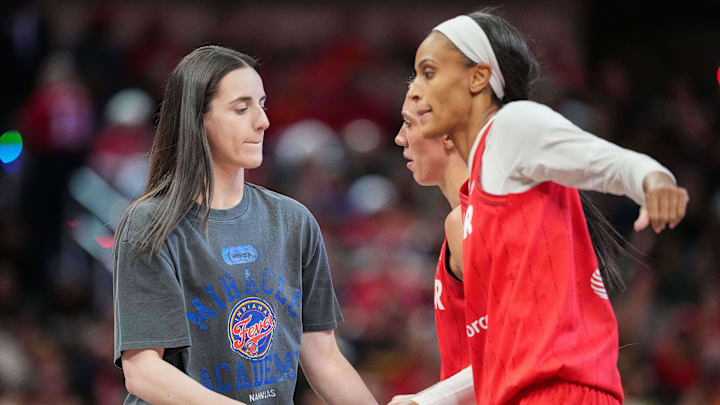 Indiana Fever guard Caitlin Clark (22) high-flves Indiana Fever forward DeWanna Bonner (25) on Friday, May 30, 2025, during the game at Gainbridge Fieldhouse in Indianapolis. The Connecticut Sun defeated the Indiana Fever, 85-83.