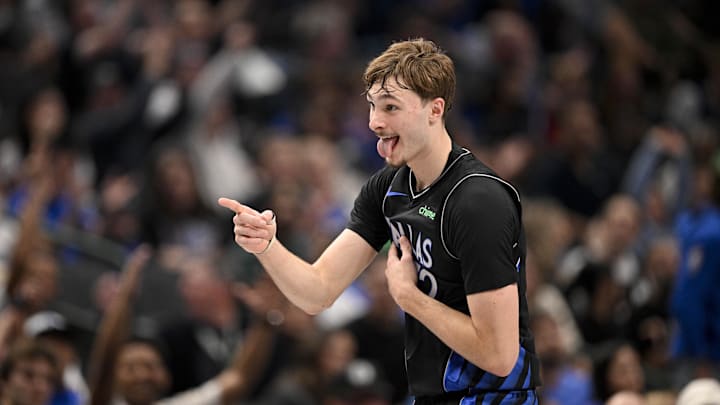 Dec 23, 2025; Dallas, Texas, USA; Dallas Mavericks forward Cooper Flagg (32) points to his team bench as he celebrates scoring against the Denver Nuggets during the second quarter at the American Airlines Center. Mandatory Credit: Jerome Miron-Imagn Images
