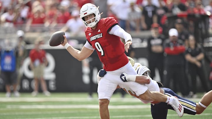 Sep 21, 2024; Louisville, Kentucky, USA;  Louisville Cardinals quarterback Tyler Shough (9) looks to pass while being tackled by Georgia Tech Yellow Jackets linebacker Kyle Efford (44) during the first quarter at L&N Federal Credit Union Stadium. Mandatory Credit: Jamie Rhodes-Imagn Images