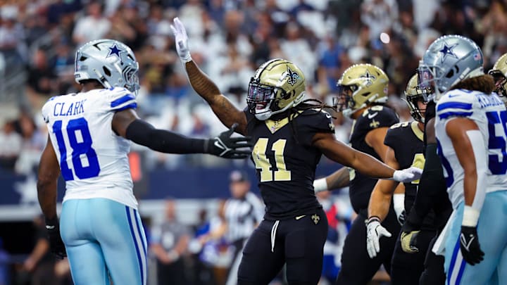 Sep 15, 2024; Arlington, Texas, USA; New Orleans Saints running back Alvin Kamara (41) celebrates in front of Dallas Cowboys linebacker Damone Clark (18) after scoring a touchdown  during the first quarter  at AT&T Stadium. Mandatory Credit: Kevin Jairaj-Imagn Images