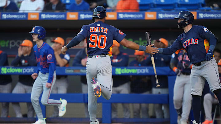 Mar 6, 2025; Port St. Lucie, Florida, USA;  Houston Astros infielder Cam Smith (90) celebrates scoring a run with teammate Chas McCormick, right, in the first inning against the New York Mets at Clover Park. Mandatory Credit: Jim Rassol-Imagn Images