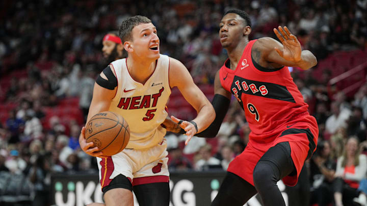 Apr 12, 2024; Miami, Florida, USA; Miami Heat forward Nikola Jovic (5) drives to the basket as Toronto Raptors guard RJ Barrett (9) defends during the first half at Kaseya Center. Mandatory Credit: Jim Rassol-Imagn Images Apr 12, 2024; Miami, Florida, USA; Miami Heat forward Nikola Jovic (5) drives to the basket as Toronto Raptors guard RJ Barrett (9) defends during the first half at Kaseya Center. Mandatory Credit: Jim Rassol-Imagn Images