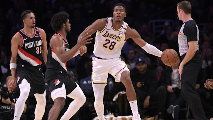 Los Angeles Lakers forward Rui Hachimura (28) is defended by Portland Trail Blazers guard Scoot Henderson (00) Los Angeles Lakers forward Rui Hachimura (28) is defended by Portland Trail Blazers guard Scoot Henderson (00)
