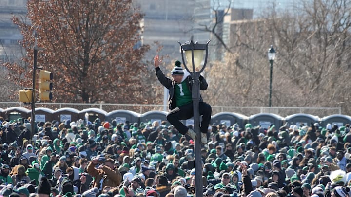 Feb 14, 2025; Philadelphia, PA, USA; A fan of the Philadelphia Eagles climbs a light pole during the Super Bowl LIX championship parade and rally. Mandatory Credit: Kirby Lee-Imagn Images Feb 14, 2025; Philadelphia, PA, USA; A fan of the Philadelphia Eagles climbs a light pole during the Super Bowl LIX championship parade and rally. Mandatory Credit: Kirby Lee-Imagn Images