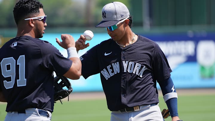Mar 9, 2025; Jupiter, Florida, USA;  New York Yankees third baseman Oswald Peraza (91) and New York Yankees first baseman  Oswaldo Cabrera (95) greet each other during warm-ups before the game against the St. Louis Cardinals at Roger Dean Chevrolet Stadium. Mandatory Credit: Jim Rassol-Imagn Images