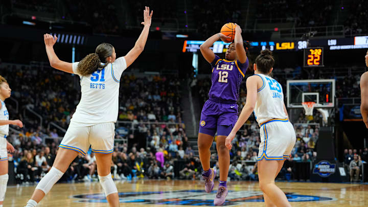 Mar 30, 2024; Albany, NY, USA; LSU Tigers guard Mikaylah Williams (12) shoots a jump shot against UCLA's Lauren Betts (51) and Gabriela Jaquez (23).