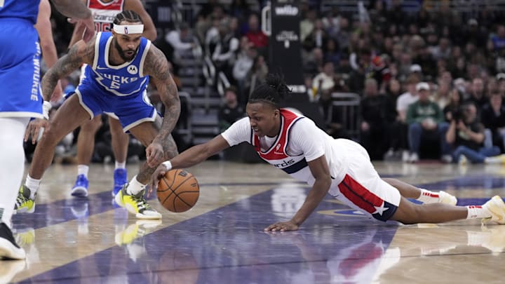 Nov 30, 2024; Milwaukee, Wisconsin, USA; Milwaukee Bucks guard Gary Trent Jr. (5) and Washington Wizards guard Carlton Carrington (8) go after a loose ball in the second half at Fiserv Forum. Mandatory Credit: Michael McLoone-Imagn Images