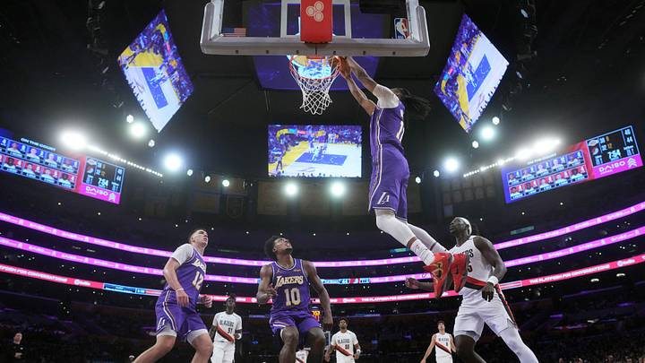 Oct 27, 2026; Los Angeles, California, USA; Los Angeles Lakers forward Ziaire Williams (11) dunks the ball against Portland Trail Blazers guard Jrue Holiday (5) as Los Angeles Lakers forward Jake LaRavia (12) and guard Collin Sexton (10) watch in the second half at Crypto.com Arena. Mandatory Credit: Kirby Lee-Imagn Images