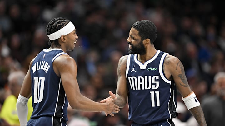 Feb 12, 2025; Dallas, Texas, USA; Dallas Mavericks guard Brandon Williams (10) and guard Kyrie Irving (11) celebrate after Irving scores against the Golden State Warriors during the second quarter at the American Airlines Center. Mandatory Credit: Jerome Miron-Imagn Images