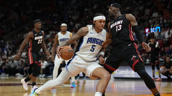 Feb 6, 2024; Miami, Florida, USA;  Orlando Magic forward Paolo Banchero (5) drives to the basket as Miami Heat center Bam Adebayo (13) defends during the second half at Kaseya Center. Mandatory Credit: Jim Rassol-Imagn Images