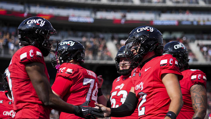 Oct 11, 2025; Cincinnati, Ohio, USA; Cincinnati Bearcats quarterback Brendan Sorsby (2) celebrates a touchdown with wide receiver Jeff Caldwell (9) against the UCF Knights in the first half at Nippert Stadium. Mandatory Credit: Aaron Doster-Imagn Images