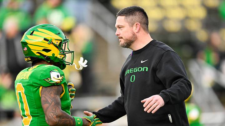 Dec 20, 2025; Eugene, OR, USA; Oregon Ducks head coach Dan Lanning greets Oregon Ducks running back Jordon Davison (0) before the game against the James Madison Dukes at Autzen Stadium. Mandatory Credit: Troy Wayrynen-Imagn Images