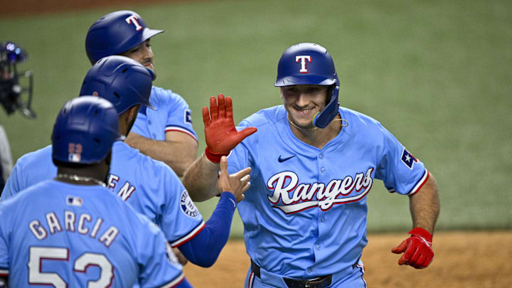 Sep 22, 2024; Arlington, Texas, USA; Texas Rangers left fielder Wyatt Langford (36) celebrates with shortstop Josh Smith (8) and second baseman Marcus Semien (2) and right fielder Adolis Garcia (53) after Langford hits a three run home run against the Seattle Mariners during the sixth inning at Globe Life Field. Sep 22, 2024; Arlington, Texas, USA; Texas Rangers left fielder Wyatt Langford (36) celebrates with shortstop Josh Smith (8) and second baseman Marcus Semien (2) and right fielder Adolis Garcia (53) after Langford hits a three run home run against the Seattle Mariners during the sixth inning at Globe Life Field.