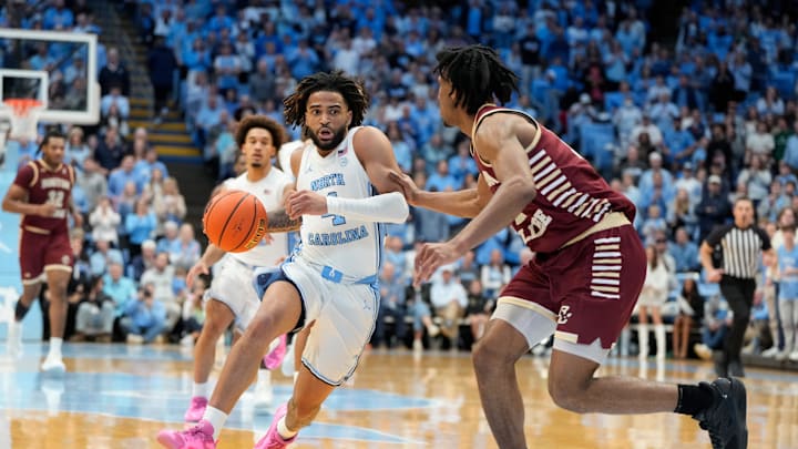 Jan 25, 2025; Chapel Hill, North Carolina, USA;  North Carolina Tar Heels guard RJ Davis (4) dribbles as Boston College Eagles guard Joshua Beadle (7) defends in the second half at Dean E. Smith Center. Mandatory Credit: Bob Donnan-Imagn Images