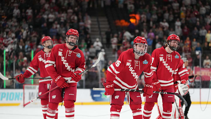 Apr 11, 2026; Las Vegas, Nevada, United States; Wisconsin Badgers defenseman Luke Osburn (2) and defenseman Weston Knox (26) react after losing to the Denver Pioneers in the championship game of the NCAA men's ice hockey Frozen Four at T-Mobile Arena. Mandatory Credit: Lucas Peltier-Imagn Images