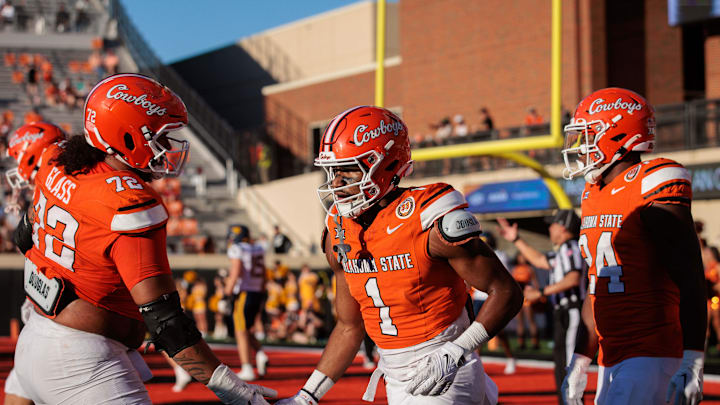 Oct 5, 2024; Stillwater, Oklahoma, USA; Oklahoma State Cowboys offensive lineman Isaia Glass (72) claps hands with wide receiver De'Zhaun Stribling (1) after a touchdown against the West Virginia Mountaineers during the fourth quarter at Boone Pickens Stadium. Mandatory Credit: William Purnell-Imagn Images Oct 5, 2024; Stillwater, Oklahoma, USA; Oklahoma State Cowboys offensive lineman Isaia Glass (72) claps hands with wide receiver De'Zhaun Stribling (1) after a touchdown against the West Virginia Mountaineers during the fourth quarter at Boone Pickens Stadium. Mandatory Credit: William Purnell-Imagn Images