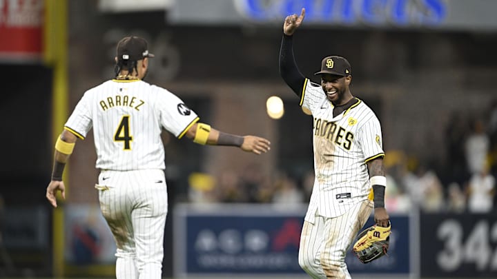 Oct 2, 2024; San Diego, California, USA; San Diego Padres first baseman Luis Arraez (4) and outfielder Jurickson Profar (10) celebrate after winning the Wildcard round for the 2024 MLB Playoffs against the Atlanta Braves at Petco Park. Mandatory Credit: Denis Poroy-Imagn Images