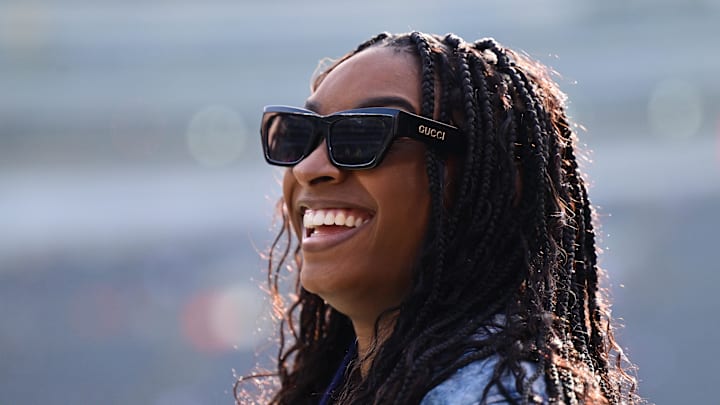Chicago, Illinois, USA; United States gymnast Simone Biles stands on the sideline before the game between the Chicago Bears and Minnesota Vikings at Soldier Field.