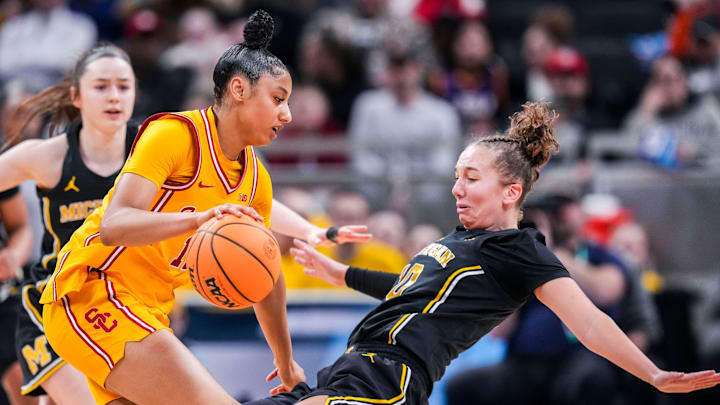 Michigan Wolverines guard Jordan Hobbs (10) takes a charge from USC Trojans guard JuJu Watkins (12) on Saturday, March 8, 2025, in a semifinals game at the 2025 TIAA Big Ten Women's Basketball Tournament between the Iowa Hawkeyes and the Ohio State Buckeyes at Gainbridge Fieldhouse in Indianapolis.