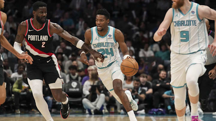 Apr 3, 2024; Charlotte, North Carolina, USA; Charlotte Hornets forward Brandon Miller (24) brings the ball up court against Portland Trail Blazers center Deandre Ayton (2) during the second half at Spectrum Center. Mandatory Credit: Jim Dedmon-Imagn Images