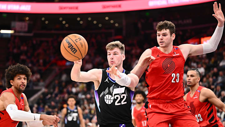 Apr 9, 2025; Salt Lake City, Utah, USA; Utah Jazz center Kyle Filipowski (22) passes off the ball in front of Portland Trail Blazers center Donovan Clingan (23) in the first half at Delta Center. Mandatory Credit: Jamie Sabau-Imagn Images Apr 9, 2025; Salt Lake City, Utah, USA; Utah Jazz center Kyle Filipowski (22) passes off the ball in front of Portland Trail Blazers center Donovan Clingan (23) in the first half at Delta Center. Mandatory Credit: Jamie Sabau-Imagn Images