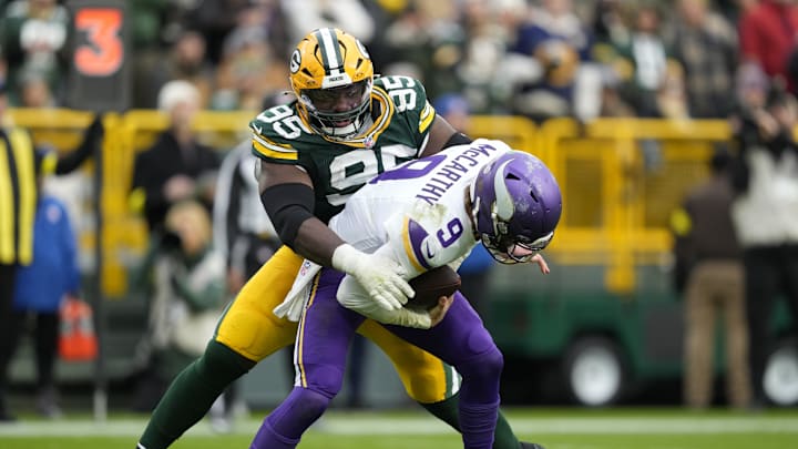 Nov 23, 2025; Green Bay, Wisconsin, USA; Minnesota Vikings quarterback J.J. McCarthy (9) is sacked by. Green Bay Packers defensive tackle Devonte Wyatt (95) during the second half at Lambeau Field. Mandatory Credit: Kayla Wolf-Imagn Images