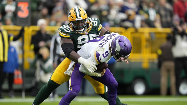Nov 23, 2025; Green Bay, Wisconsin, USA; Minnesota Vikings quarterback J.J. McCarthy (9) is sacked by. Green Bay Packers defensive tackle Devonte Wyatt (95) during the second half at Lambeau Field. Mandatory Credit: Kayla Wolf-Imagn Images