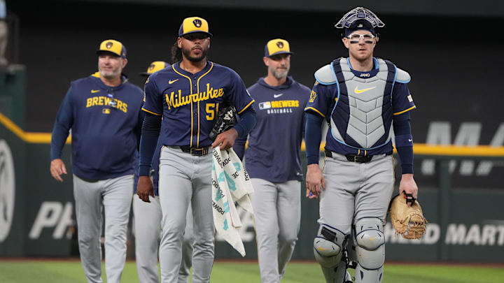 Sep 10, 2025; Arlington, Texas, USA; Milwaukee Brewers starting pitcher Freddy Peralta (51) and catcher Danny Jansen (33) walk to the dugout before the first inning against the Texas Rangers at Globe Life Field. Mandatory Credit: Jim Cowsert-Imagn Images