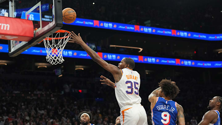 Nov 4, 2024; Phoenix, Arizona, USA; Phoenix Suns forward Kevin Durant (35) puts up a layup over Philadelphia 76ers guard Kelly Oubre Jr. (9) during the first half at Footprint Center. Mandatory Credit: Joe Camporeale-Imagn Images