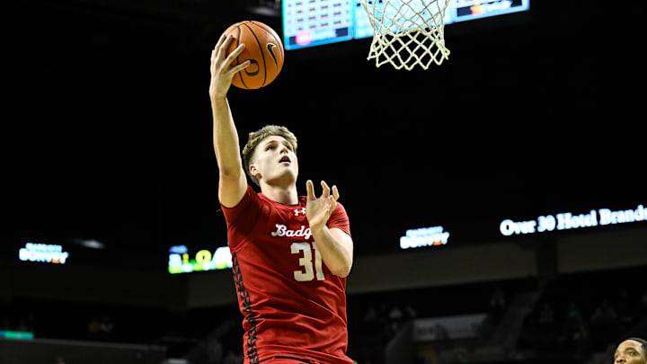 Feb 25, 2026; Eugene, Oregon, USA; Wisconsin Badgers forward Nolan Winter (31) scores during the second half against the Oregon Ducks at Matthew Knight Arena. 