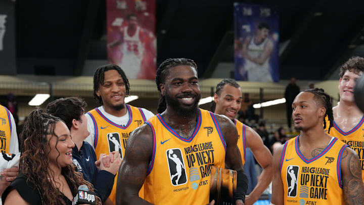 Feb 16, 2025; Oakland, California, USA; Team Braxton guard Kevon Harris (12) of the College Park Skyhawks receives the Most Valuable Player Trophy after defeating Team Swish Cultures at Moscone Center. Mandatory Credit: Darren Yamashita-Imagn Images