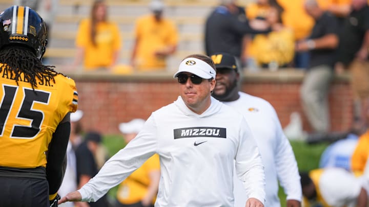 Sep 14, 2024; Columbia, Missouri, USA; Missouri Tigers head coach Eli Drinkwitz greets players against the Boston College Eagles prior to a game at Faurot Field at Memorial Stadium. Mandatory Credit: Denny Medley-Imagn Images