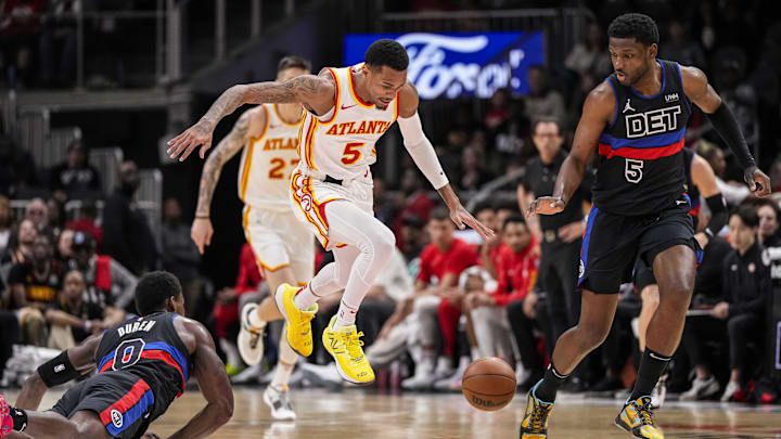 Apr 3, 2024; Atlanta, Georgia, USA; Atlanta Hawks guard Dejounte Murray (5) tries to control a loose ball between Detroit Pistons center Jalen Duren (0) and guard Jaylen Nowell (5) during the first half at State Farm Arena. Mandatory Credit: Dale Zanine-USA TODAY Sports